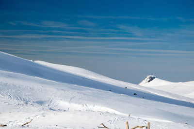 Snow covered mountain against blue sky