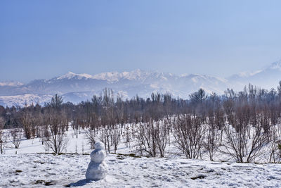 Park of first president, almaty, kazakhstan. snowman and mountains of the zaili alatau