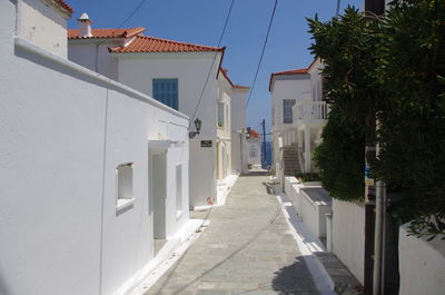 Footpath amidst buildings against sky