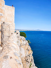 Scenic view of sea against clear blue sky