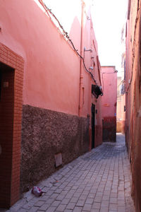 Narrow street amidst buildings against sky