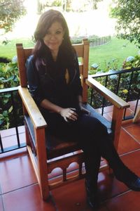 Portrait of young woman sitting on chair