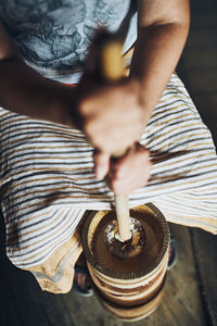 Woman making butter with butter churn. old traditional method making of butter