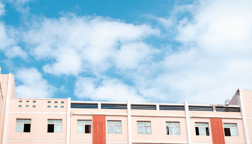 Low angle view of building against cloudy sky