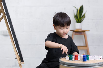 Cute boy sitting on table