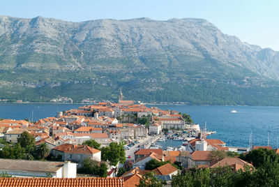 High angle view of townscape by sea