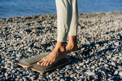 Close-up of a foot on a board with nails, spiritual practice of acupuncture and acupressure.