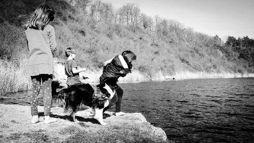 People on shore throwing rocks