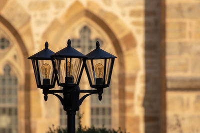 Close-up of street light against building