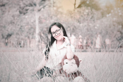 Portrait of young woman in field