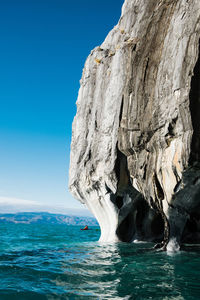 Marble caves of puerto rio tranquilo in chile, person kayaking in the distance