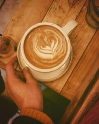 Cropped image of hand holding coffee