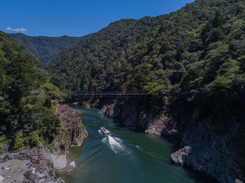 High angle view of river amidst trees against sky