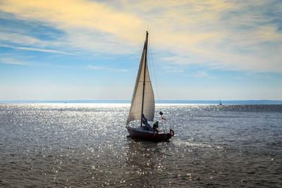 Sailboat on sea against sky