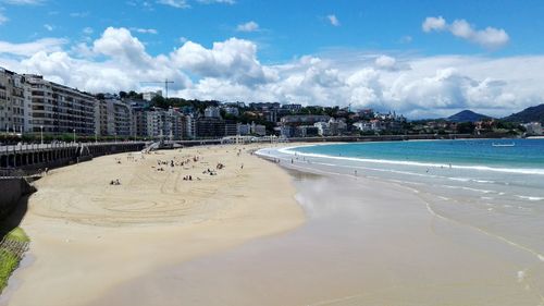 Panoramic view of beach and buildings against sky