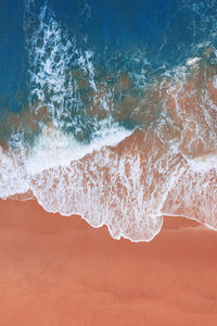 Close-up of wave splashing on beach