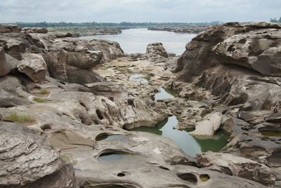 Rocks in sea against sky