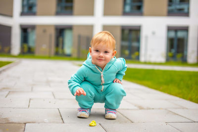 Portrait of cute boy on footpath