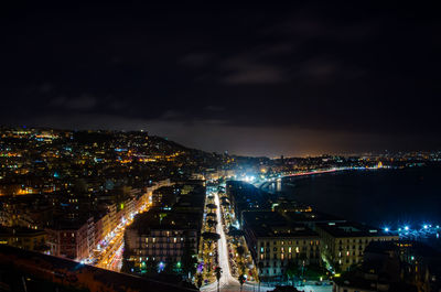 Illuminated cityscape against sky at night