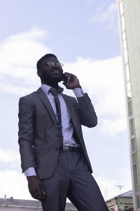 Low angle view of a man looking away against sky