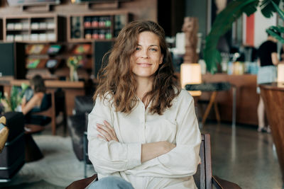 Portrait of young woman standing in city