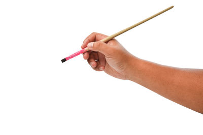 Close-up of man holding hands over white background