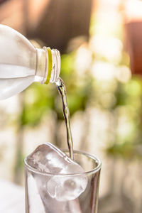 Close-up of drink pouring in glass