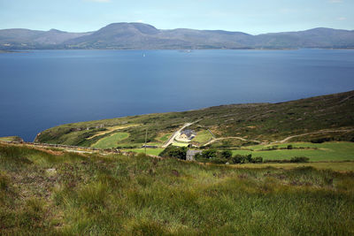 Scenic view of sea and mountains against sky