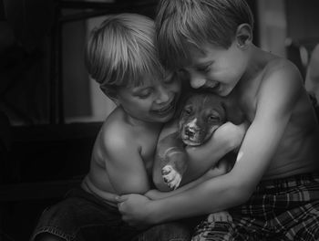 Happy sibling playing with dog