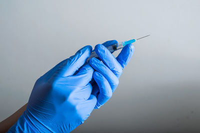 Close-up of hand holding syringe