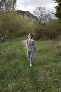 Full length of teenage girl walking on field