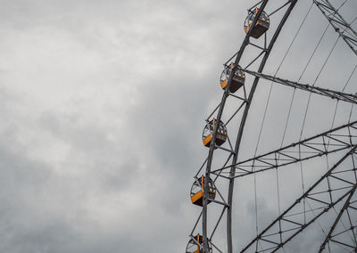 Low angle view of ferris wheel against sky