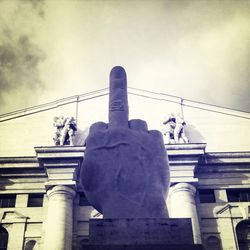 Low angle view of statue against cloudy sky