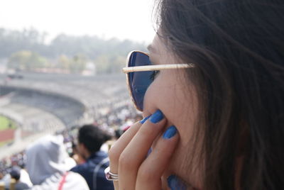 Close-up of woman in soccer stadium