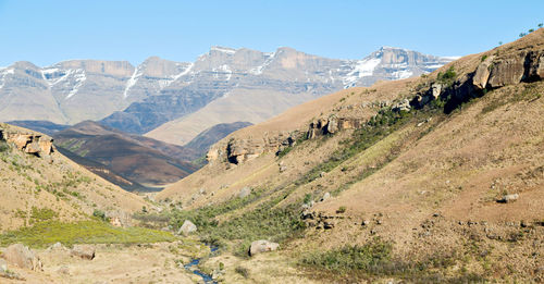 Scenic view of mountains against clear blue sky