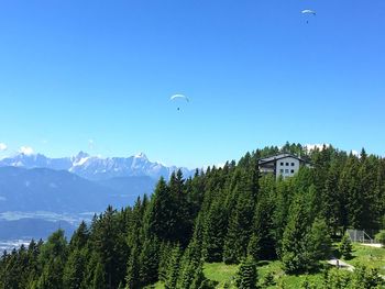 Scenic view of trees and mountains against clear sky