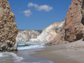 Scenic view of sea and rocky mountains