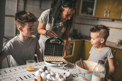 Father and son on table at home