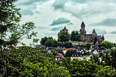 View of trees and buildings against sky