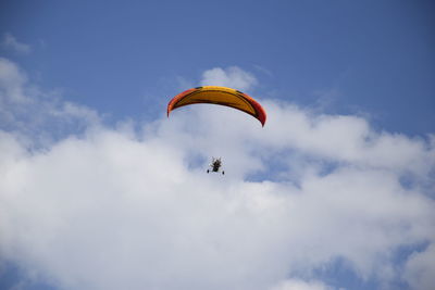 Low angle view of paragliding against sky