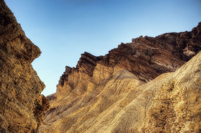 Low angle view of rock formations against sky