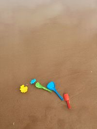 High angle view of toys on a sandy  beach