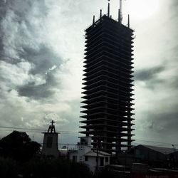 Low angle view of buildings against cloudy sky