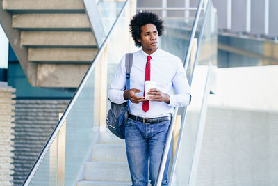 Young man standing on staircase