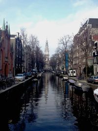 Boats in canal along buildings