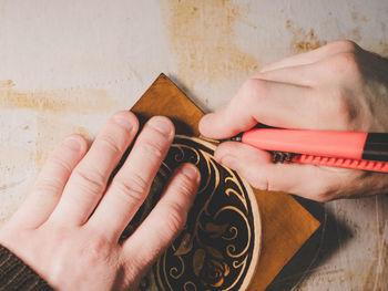 Close-up of hands working on wood