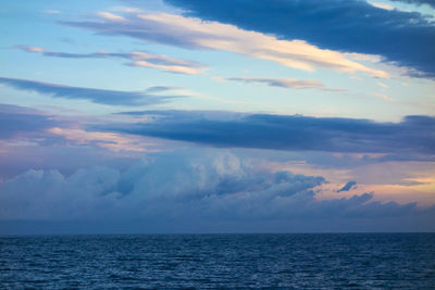 View of calm sea against cloudy sky