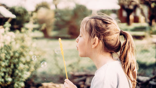 Portrait of woman against white flowering plants