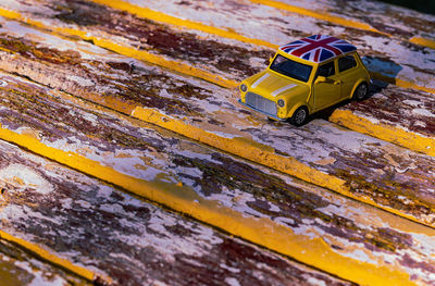 High angle view of yellow toy car on table