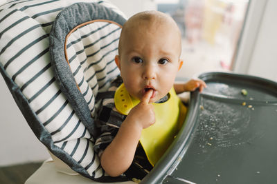 Little child with solid nutrition. baby girl eating food and mix vegetable plate